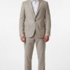 Man wearing a light beige two-piece suit with a white dress shirt and brown loafers, standing against a white background.
