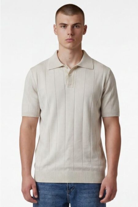 Male model wearing a beige ribbed short-sleeve polo shirt standing against a white background.