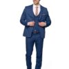 Man in a blue suit posing and adjusting his jacket, smiling against a white background