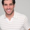 Portrait of a smiling man wearing a white striped polo shirt, facing the camera.