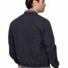 Back view of a man wearing a navy bomber jacket with striped ribbed cuffs and hem; a gray shirt peeks out underneath.