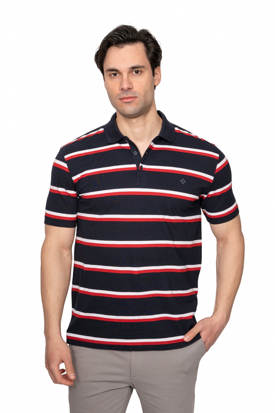 IMG_4892jpg - Noble Man wearing a navy polo with red and white horizontal stripes, standing against a white background, with hands in pockets (casual model shot).