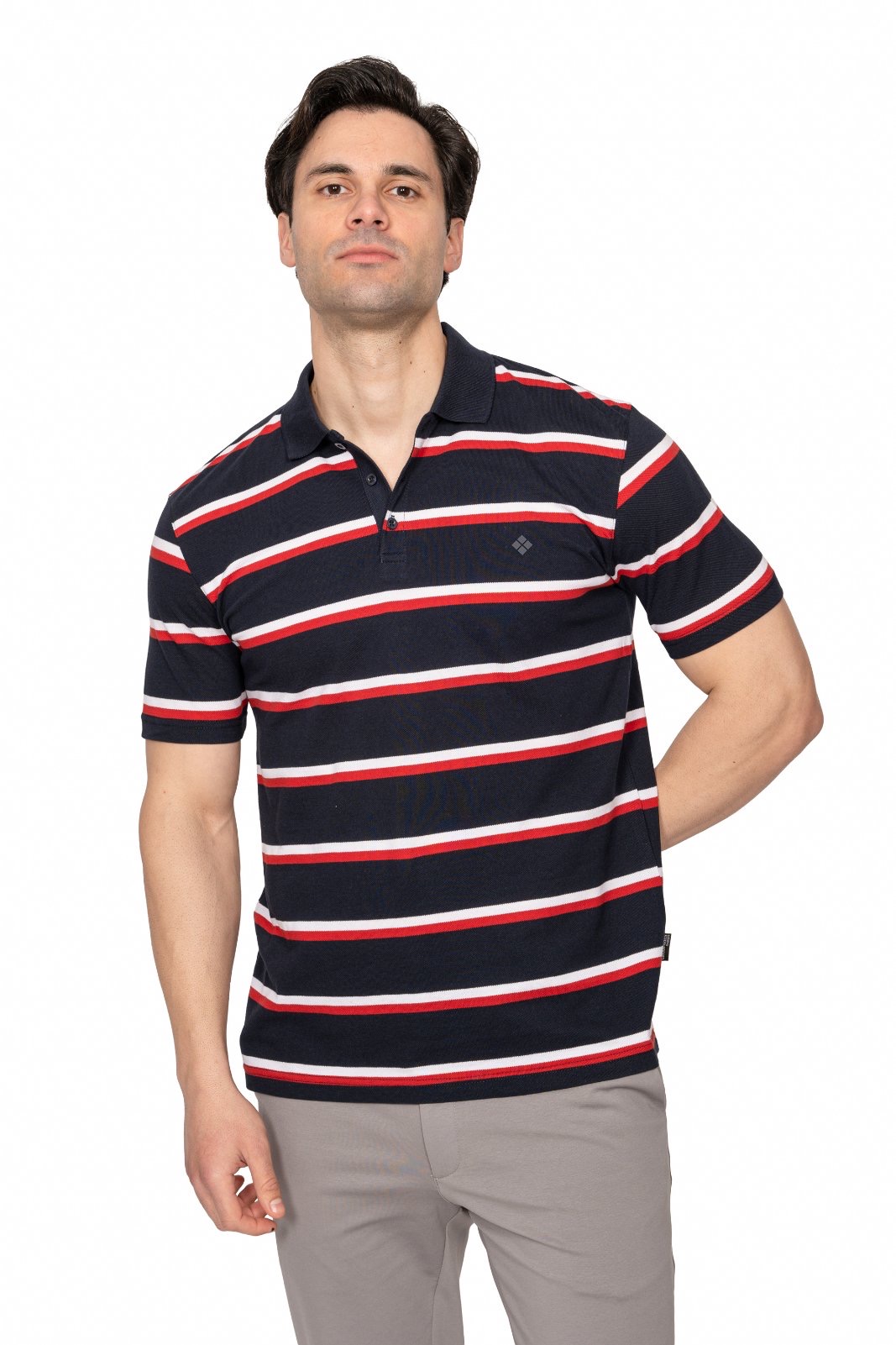 IMG_4895jpg - Noble Man modeling a navy polo shirt with red and white horizontal stripes, standing with one hand on his hip against a white background.