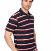 Male model wearing a navy polo with red and white horizontal stripes, facing camera with hands in pockets.