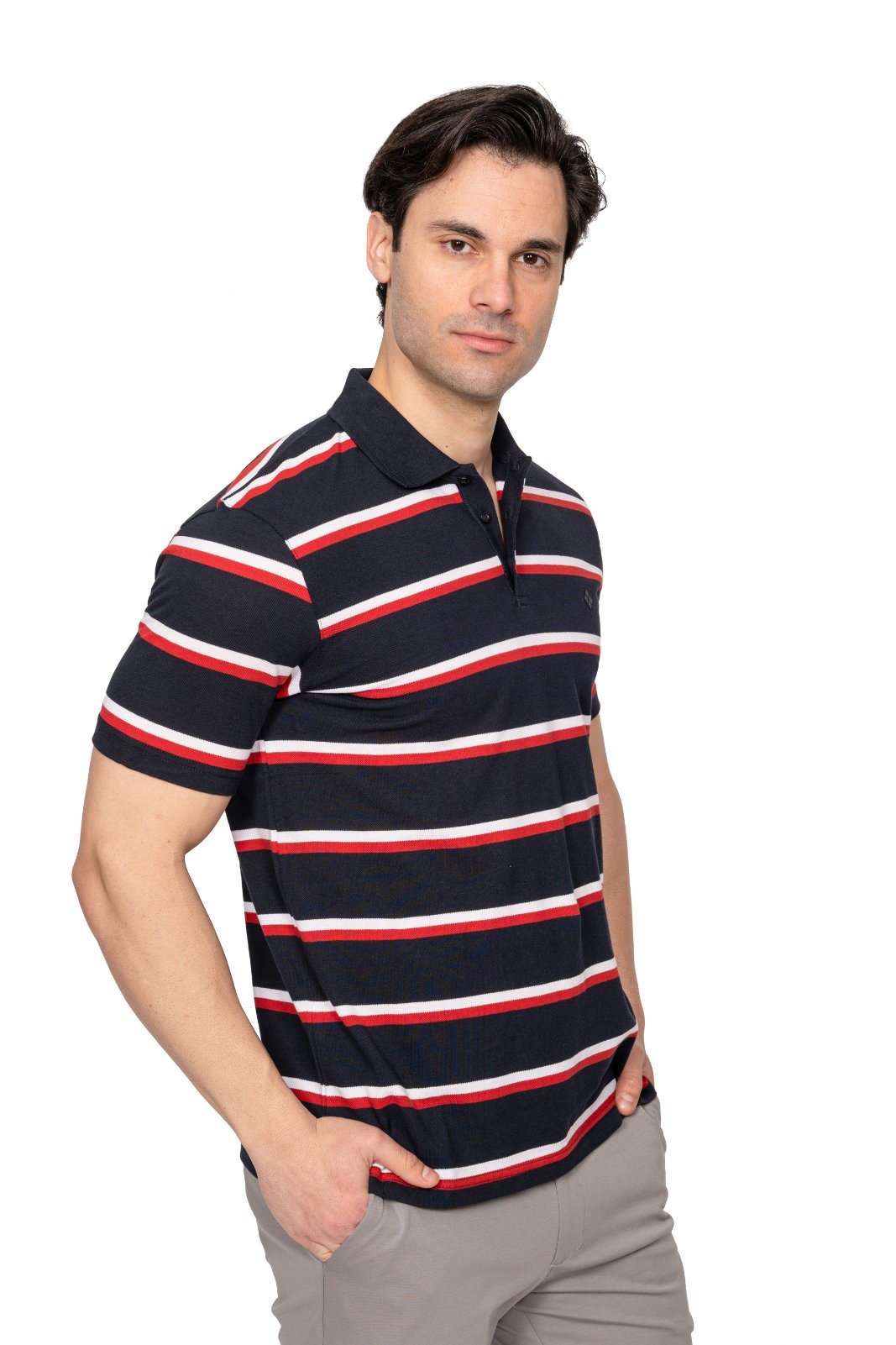 IMG_4896jpg - Noble Male model wearing a navy polo with red and white horizontal stripes, facing camera with hands in pockets.