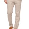 Beige men's chinos with hands in pockets, paired with brown suede sneakers and a dark green top (full outfit view).