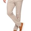 Man wearing beige chinos with one hand in pocket and brown suede sneakers with white soles in a casual stance
