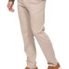 Person wearing beige chinos with hands in pockets, paired with a dark green sweater and brown suede sneakers.