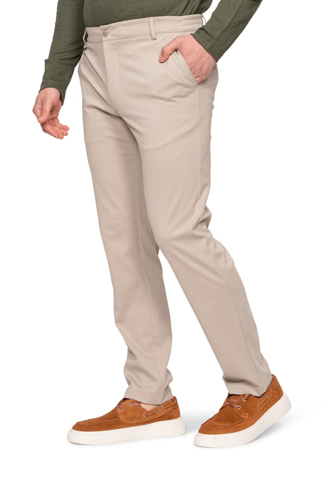 IMG_4908jpg - Noble Person wearing beige chinos with hands in pockets, paired with a dark green sweater and brown suede sneakers.