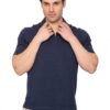 Man adjusting the collar of a navy polo shirt, looking at the camera against a white background.