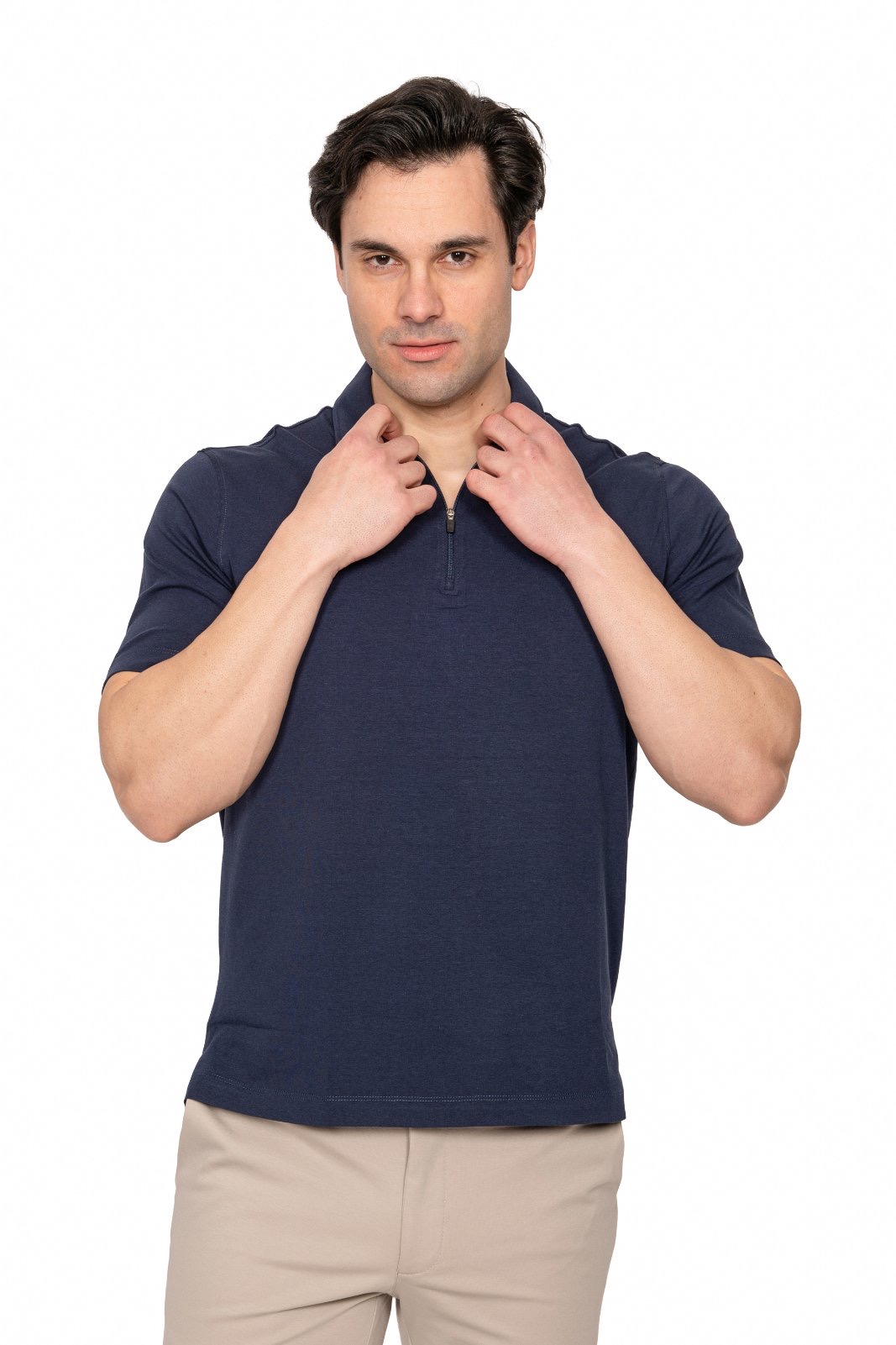 IMG_4925jpg - Noble Man adjusting the collar of a navy polo shirt, looking at the camera against a white background.