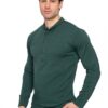 Male model wearing a green long-sleeve Henley shirt and beige pants in a studio on a white background.