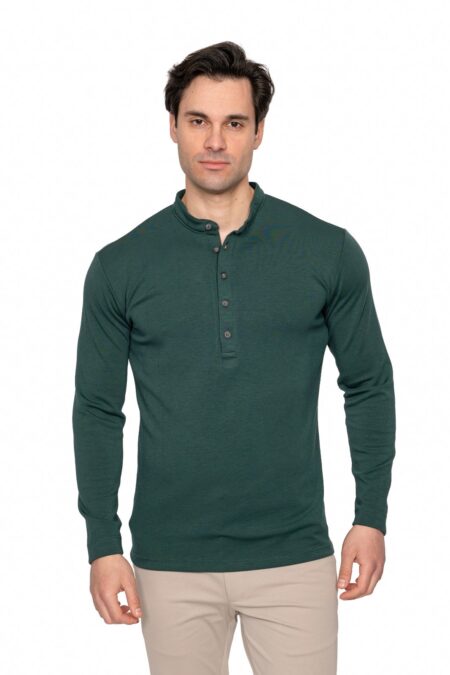 Male model wearing a dark green long-sleeve Henley shirt and beige pants, posing against a white studio background.