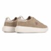 Beige sneaker with a white chunky sole, perforated side panels, and stitched branding on the side; back heel tab shows '83' on a light panel; casual athletic shoe look.