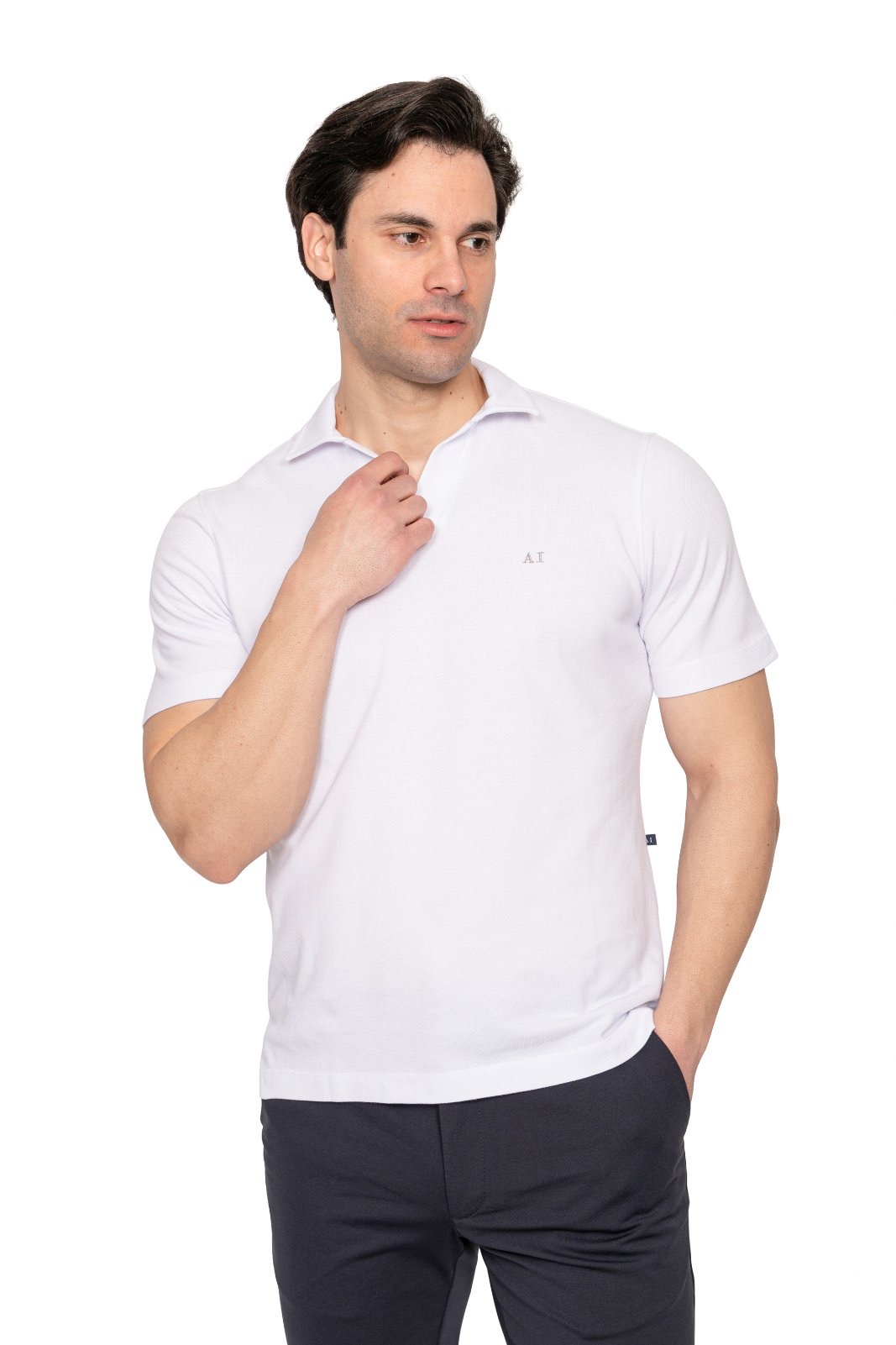 IMG_4968jpg - Noble Man wearing a white polo shirt with a small logo, posing with one hand at the collar against a white background.