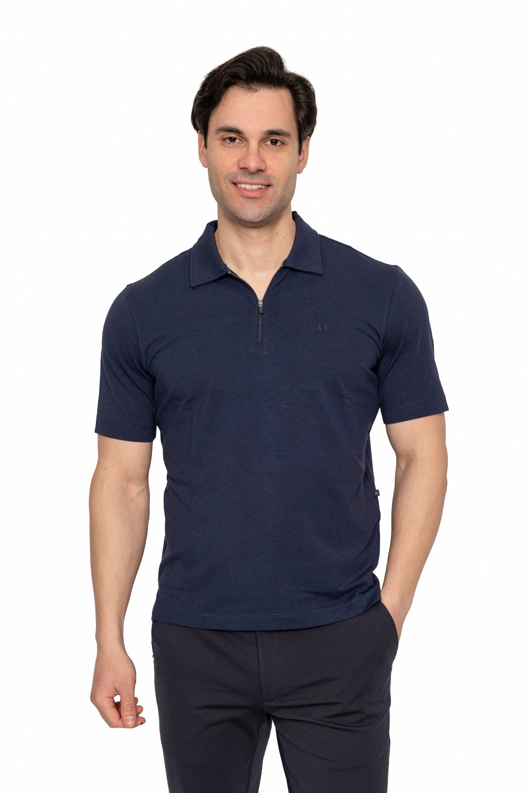 IMG_5011jpg - Noble Man wearing a navy polo shirt standing against a white background, smiling at the camera.