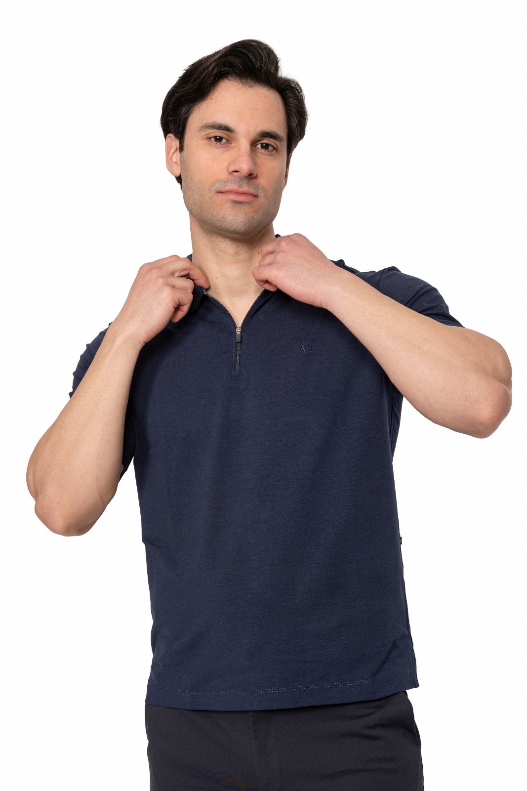 IMG_5052jpg - Noble Man in a navy zip-neck shirt adjusting the zipper at the neckline.
