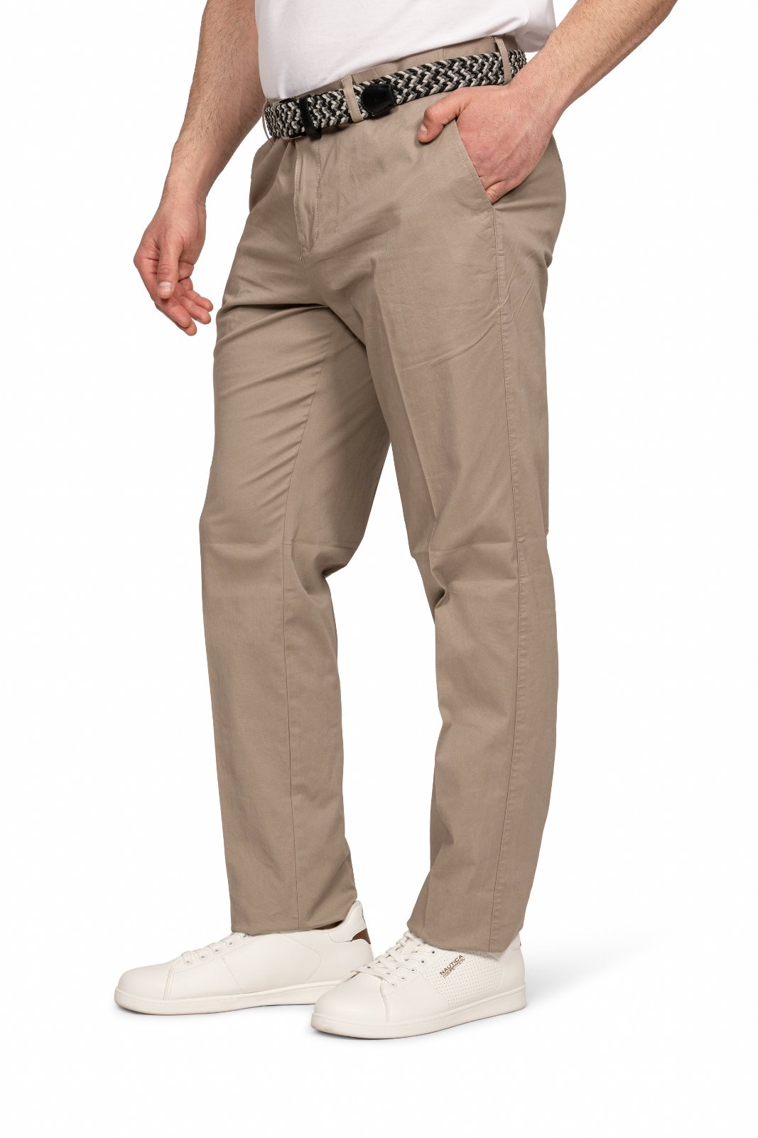 IMG_5126jpg - Noble Person wearing beige chinos with a black-and-white woven belt and white sneakers, standing with one hand in pocket.