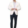 Man in a white blazer, light striped shirt, navy trousers, and white sneakers posing while buttoning his blazer.