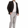 Man posing in a dark brown blazer over a white T-shirt, light gray trousers, and white sneakers against a white backdrop.