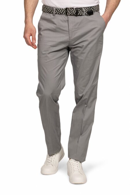 Man wearing light gray chinos with a woven belt and white sneakers, posed mid-stride against a white background.