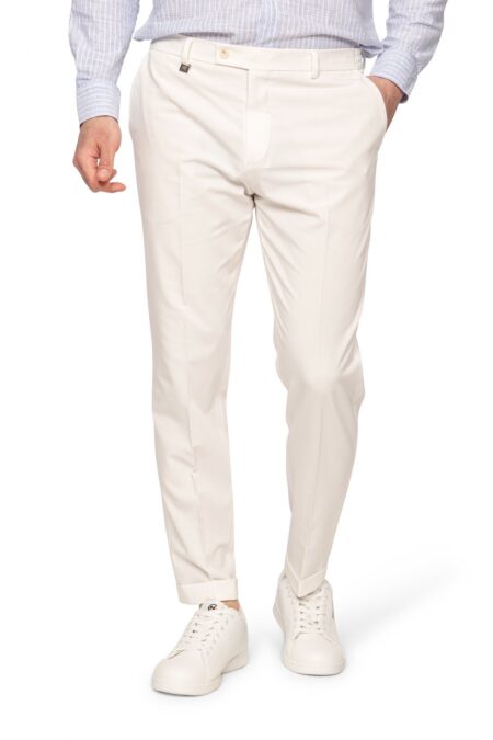 Man wearing light beige chinos with cuffs, blue striped shirt, and white sneakers; casual smart outfit from the waist down to feet.