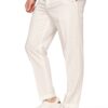 Man wearing cream chinos with cuffed hems and white sneakers, standing in a relaxed pose