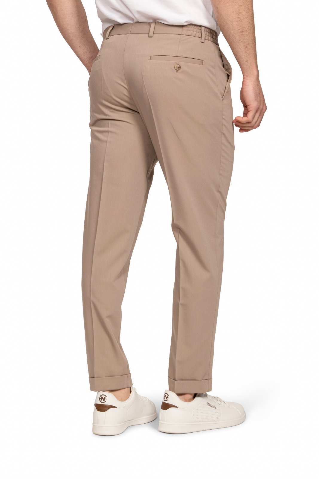 IMG_5196jpg - Noble Back view of a man wearing tan chinos, white shirt, and white sneakers; hands at sides, shows rear welt pocket with button detail.
