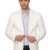 Man in a white blazer and light striped shirt adjusts his jacket in a studio portrait.
