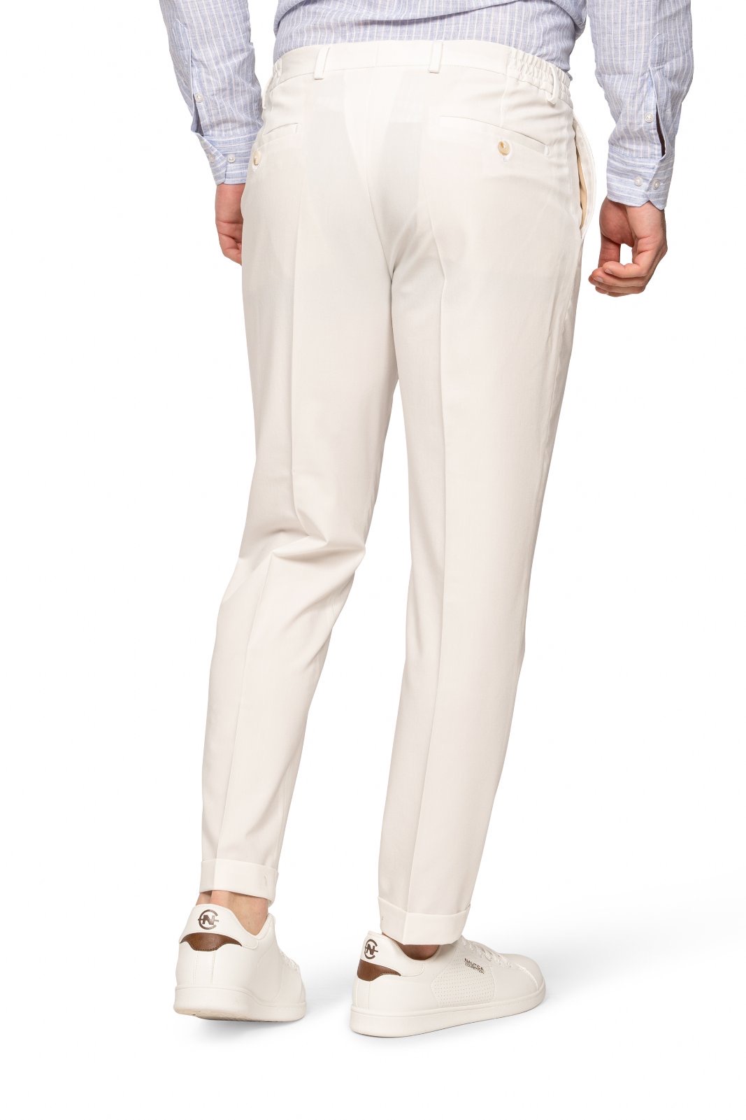 IMG_5246-1jpg - Noble Back view of a person wearing cream chinos, a light striped shirt, and white sneakers.
