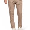 Beige chinos with a white shirt and white sneakers; person standing with one hand in pocket on white background.